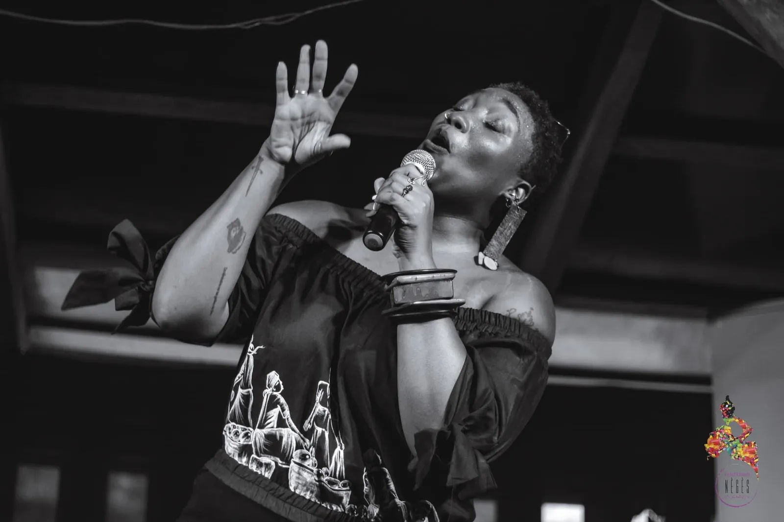 A singer with a microphone, in black and white