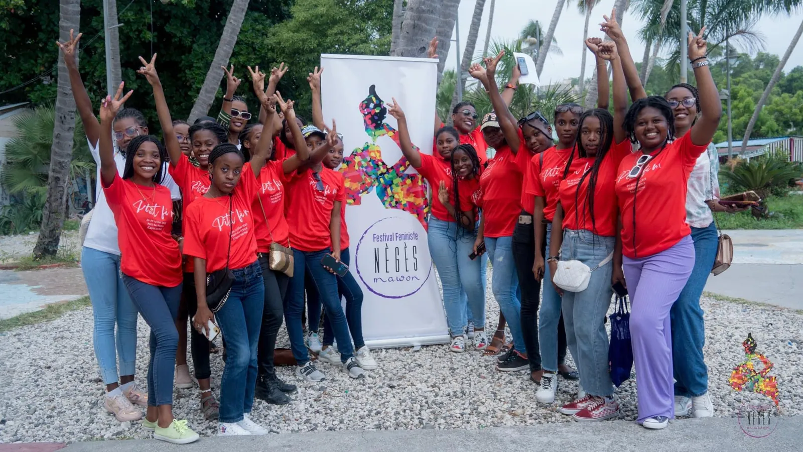 Women in red festival T-shirts cheering with raised arms